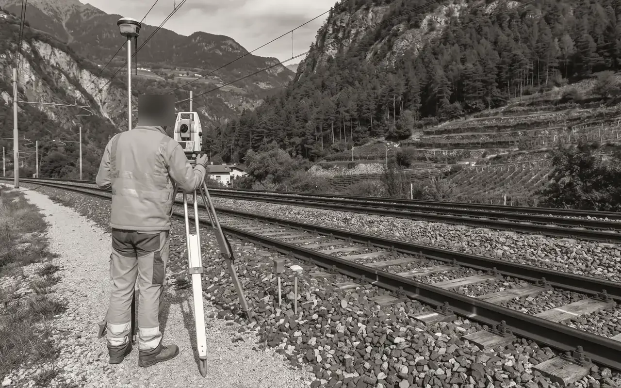 Topographic survey with total station along the railway line (illustrative image)